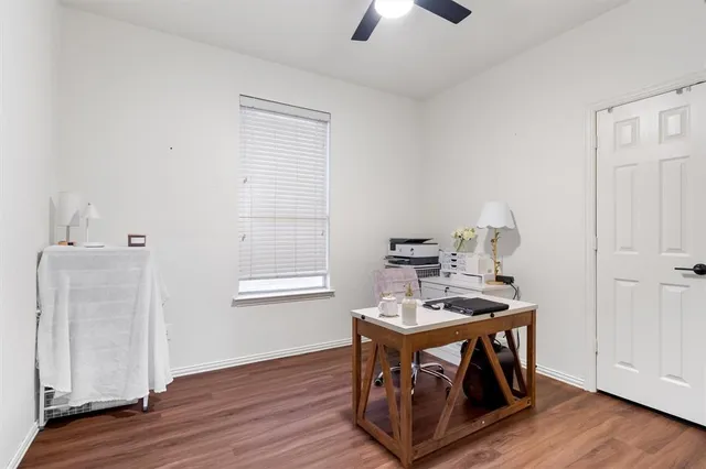 a view of a workspace with furniture and wooden floor