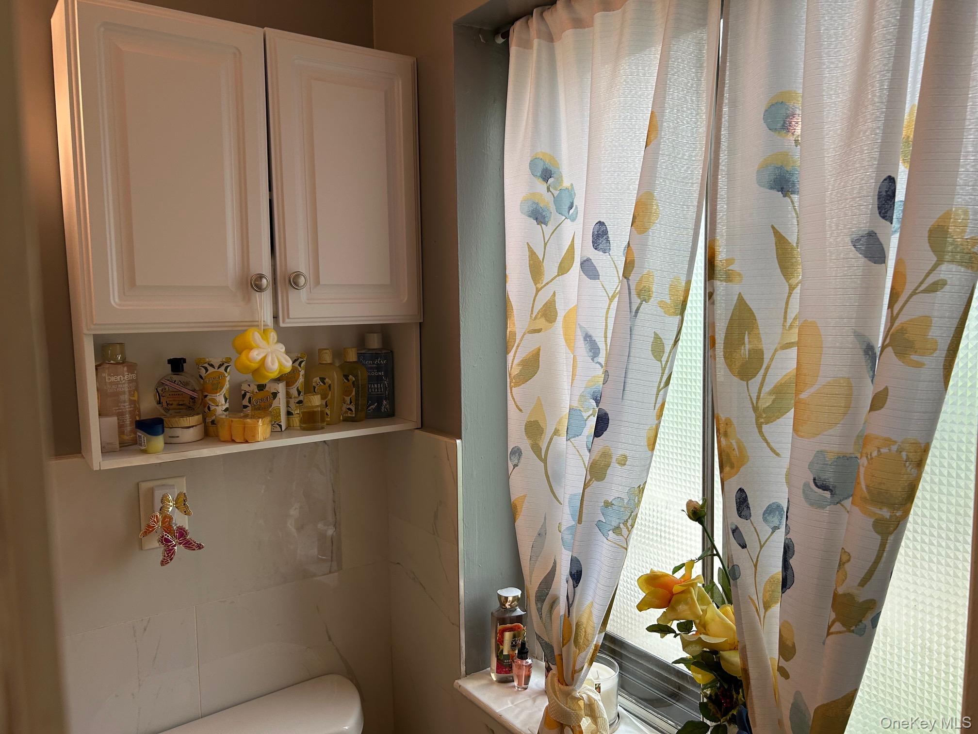 2 Secora Road, Unit C20 Monsey, NY 10952 - Photo 24 of 34 a bathroom with a window and shower curtain