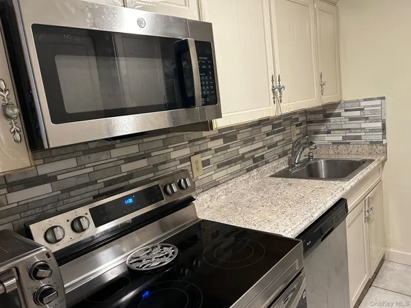 a kitchen with a stove microwave and sink