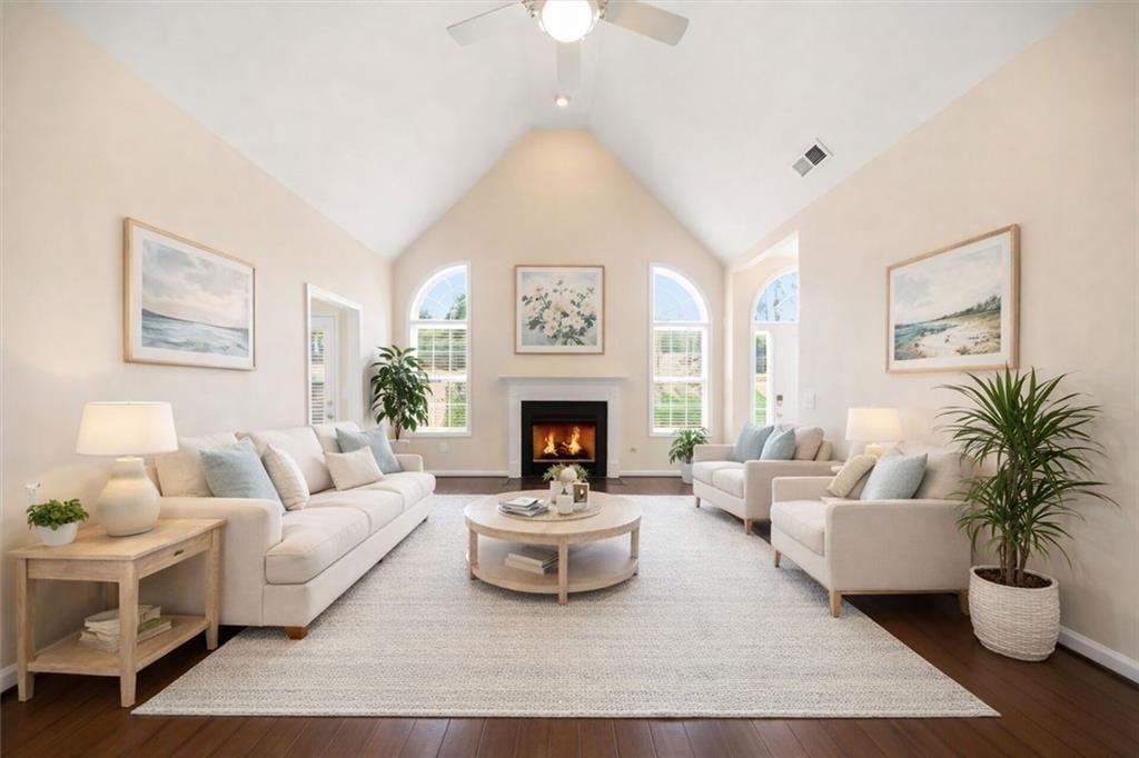 111 Stonegate Lane Canton, GA 30114 - Photo 4 of 30 a living room with furniture a fireplace and a chandelier