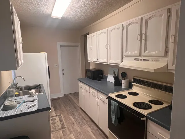 a kitchen with a stove and a sink