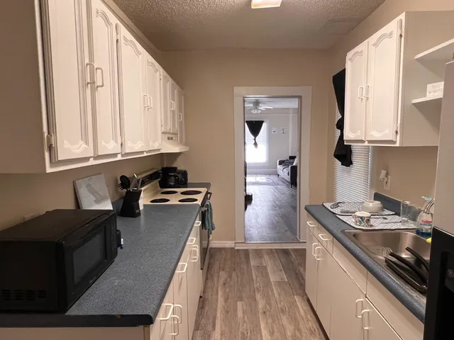 a kitchen with stainless steel appliances granite countertop a stove and a refrigerator