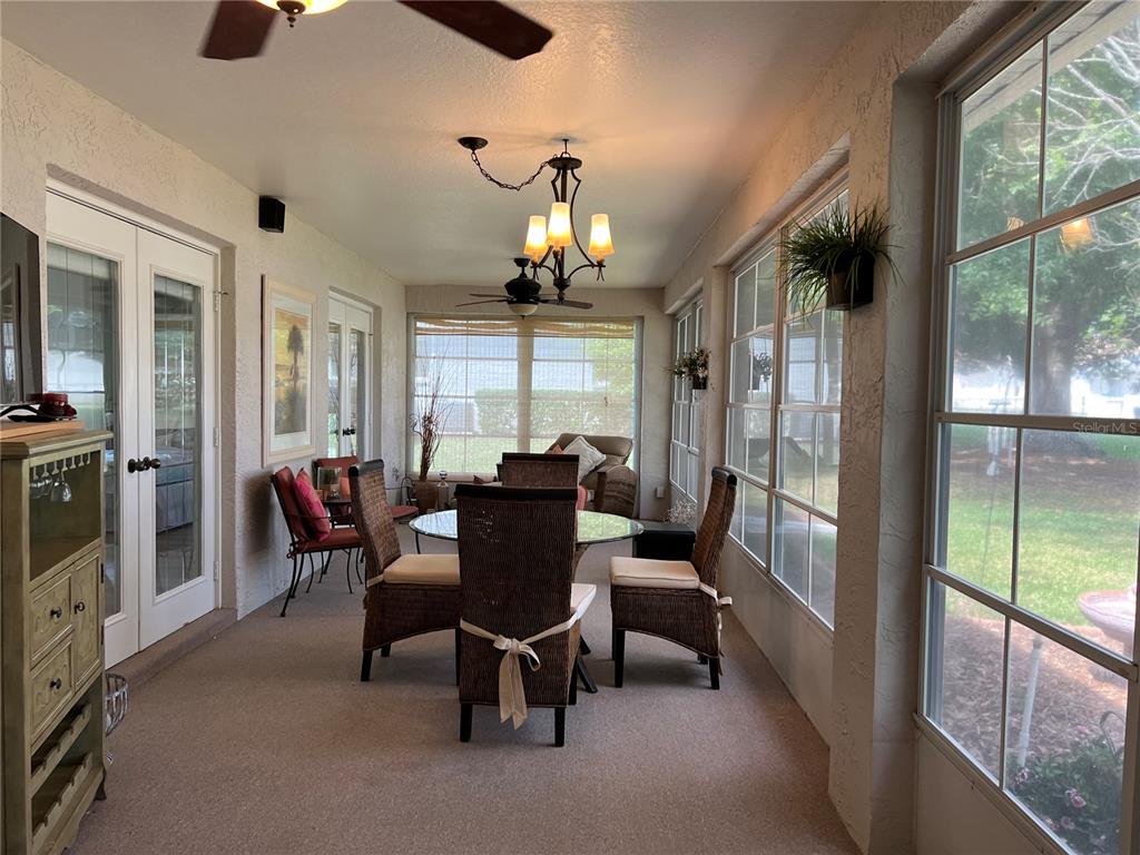 5333 Northwest 25th Loop Ocala, FL 34482 - Photo 13 of 20 a view of a dining room with furniture a chandelier and large windows