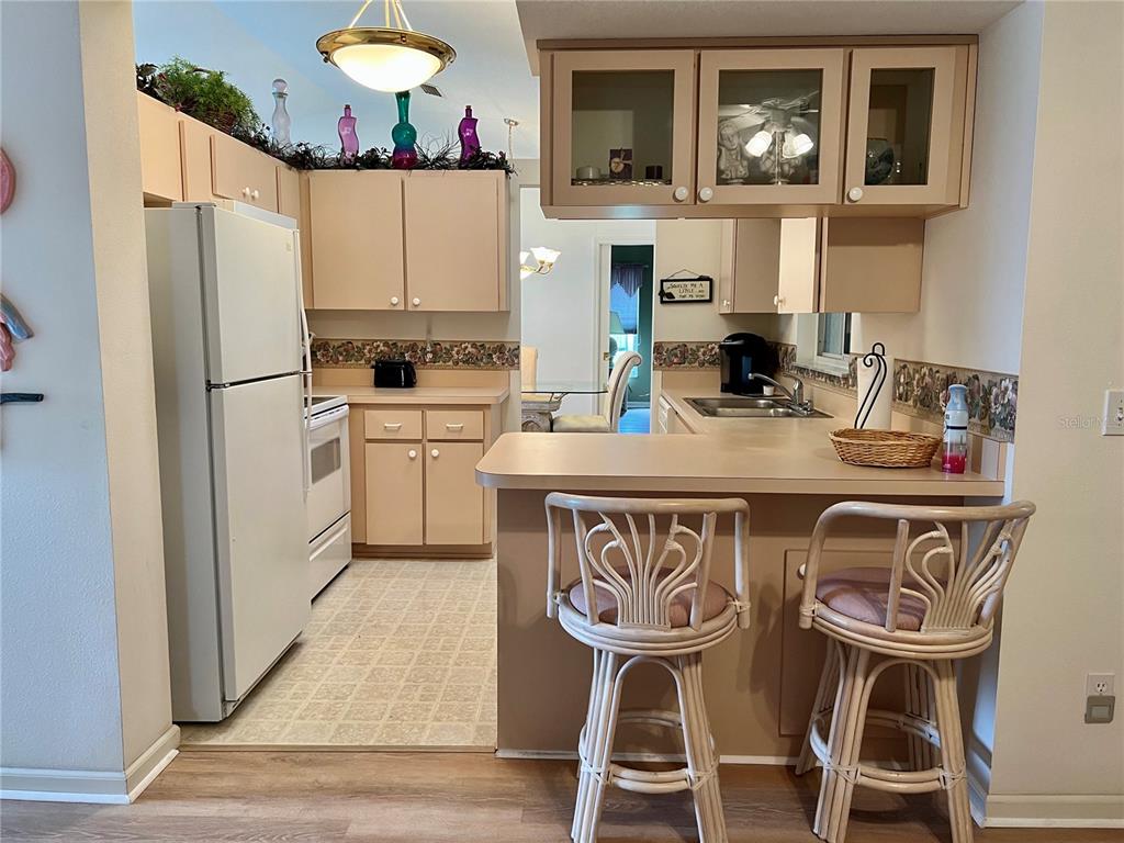 5333 Northwest 25th Loop Ocala, FL 34482 - Photo 16 of 20 a kitchen with stainless steel appliances granite countertop a dining table chairs refrigerator and sink