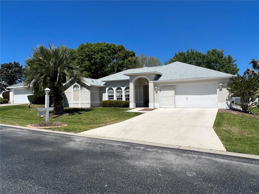 5333 Northwest 25th Loop Ocala, FL 34482 - Photo 19 of 20 a front view of a house with a yard and garage