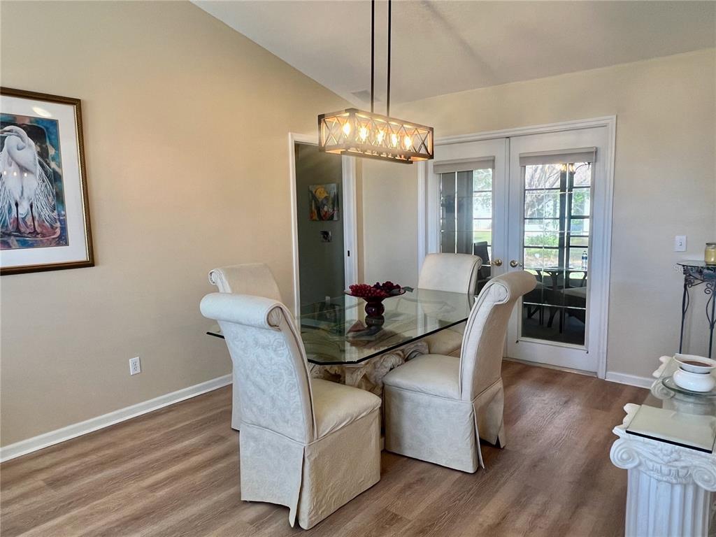 5333 Northwest 25th Loop Ocala, FL 34482 - Photo 4 of 20 a view of a dining room with furniture a chandelier and wooden floor