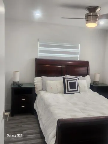 a bedroom with a bed and window