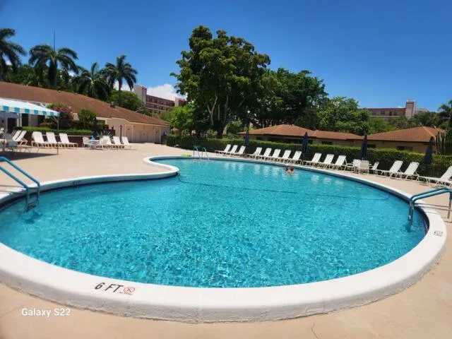 a view of a swimming pool with an outdoor seating