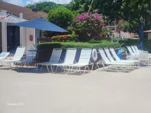 a view of a swimming pool with lounge chairs