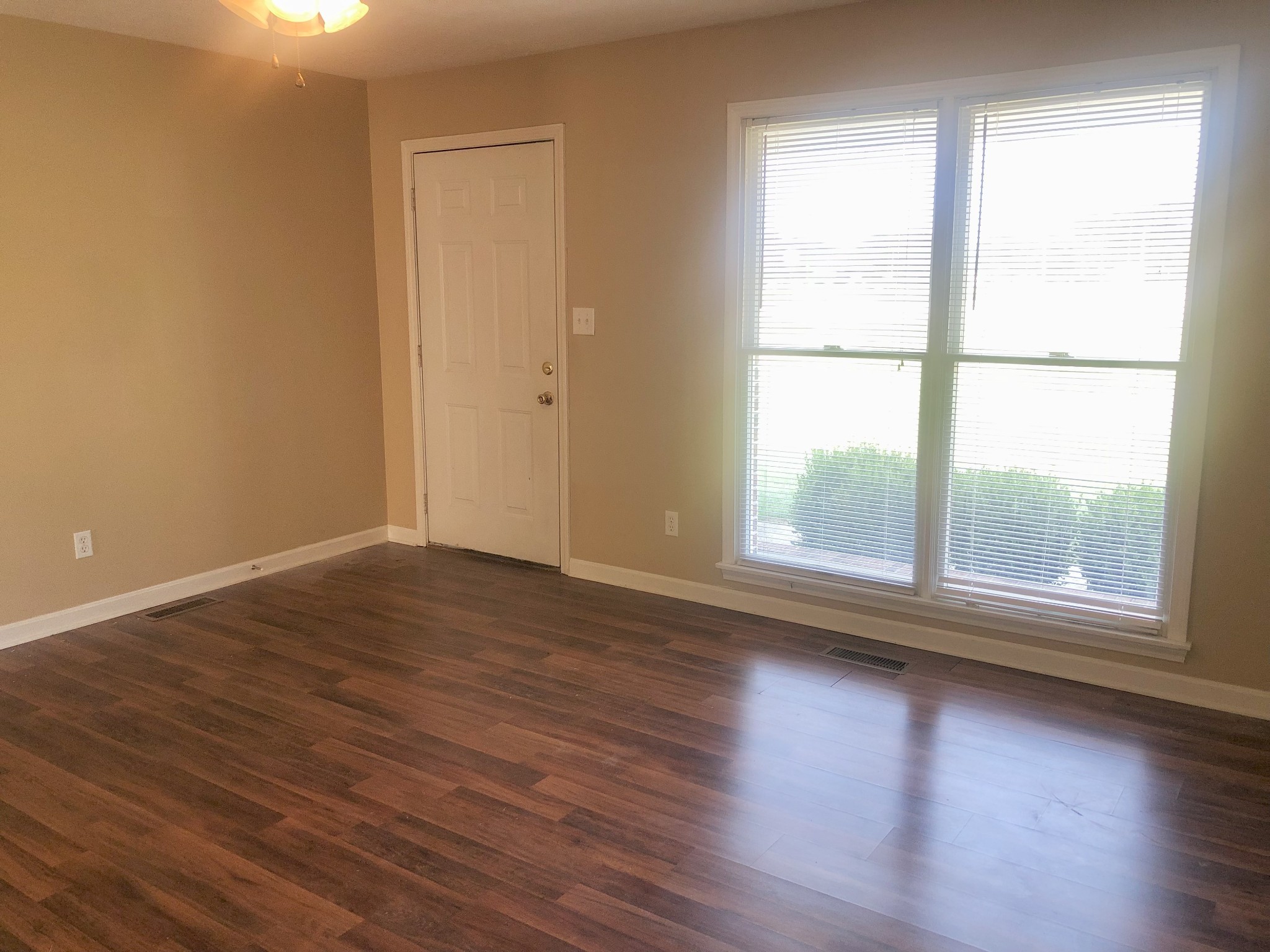 1230 Pyle Lane Hopkinsville, KY 42240 - Photo 2 of 10 an empty room with wooden floor and windows