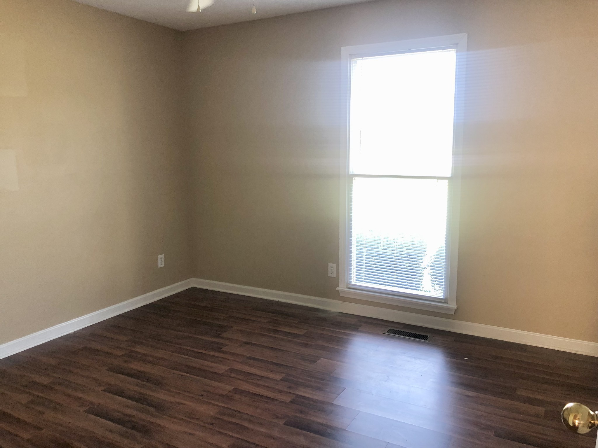 1230 Pyle Lane Hopkinsville, KY 42240 - Photo 4 of 10 an empty room with wooden floor and next to a window