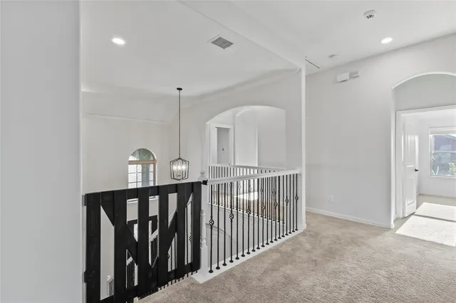 a view of a hallway with windows