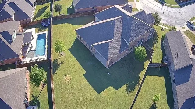 a aerial view of a house with a swimming pool