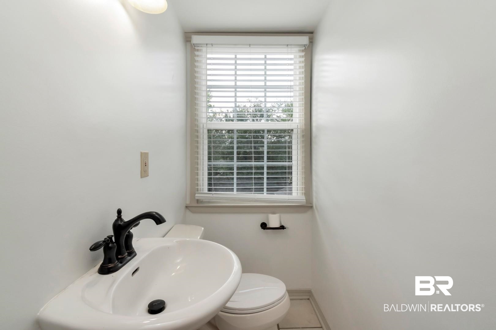 605 St Francis Street Mobile, AL 36602 - Photo 28 of 40 Bathroom featuring baseboards, a sink, and toilet
