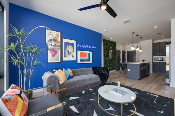 a living room with furniture and wooden floor