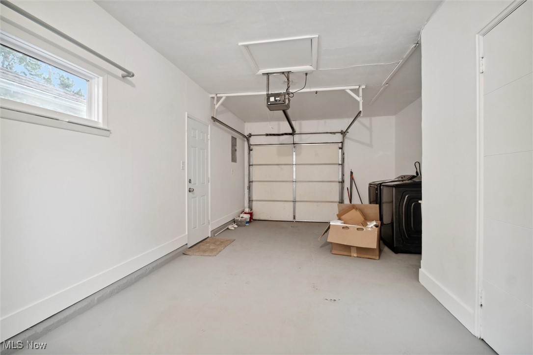 8796 West Ridgewood Drive Cleveland, OH 44130 - Photo 32 of 38 Garage with washer / clothes dryer and a garage door opener