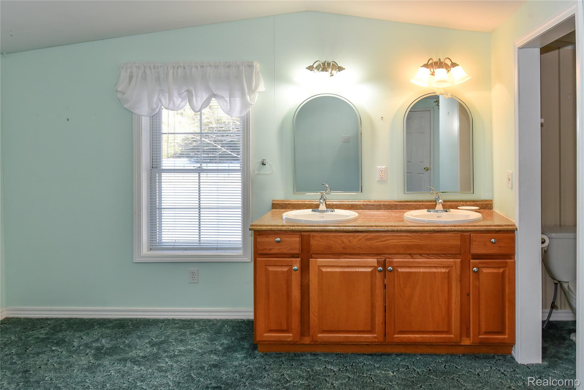 1094 Blamer Road Fairview, MI 48621 - Photo 50 of 97 Bathroom featuring double vanity and dark carpet