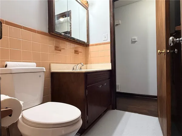 a bathroom with a sink a toilet and mirror