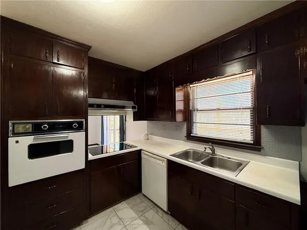 a kitchen with a sink cabinets and stainless steel appliances