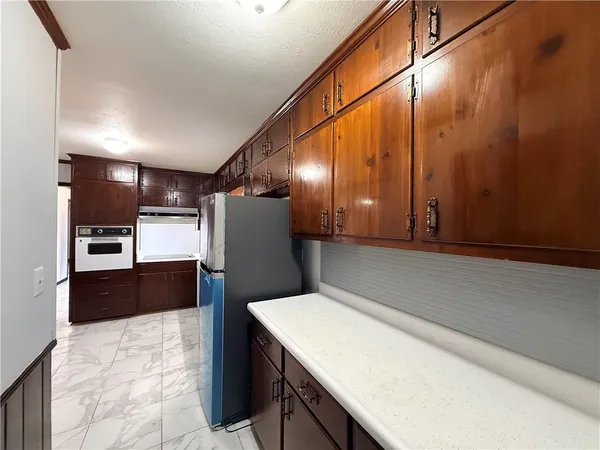 a kitchen with stainless steel appliances a refrigerator and a counter space