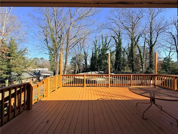a view of balcony with wooden floor and outdoor seating