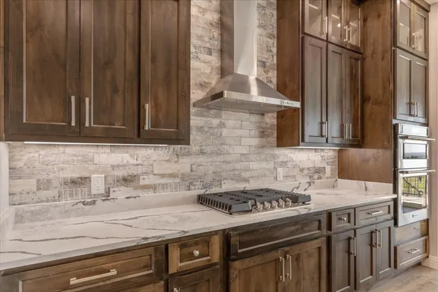 a kitchen with granite countertop a sink stove and cabinets