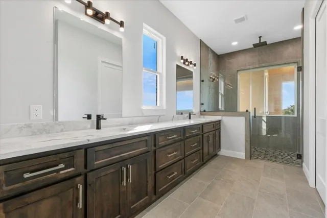 a spacious bathroom with a granite countertop sink mirror and double