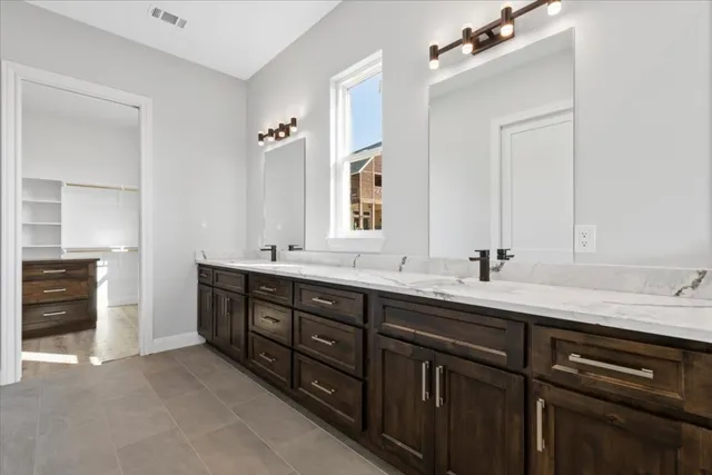 a spacious bathroom with a double vanity sink double and a mirror