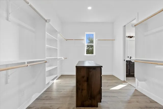 a view of hallway with wooden floor and staircase
