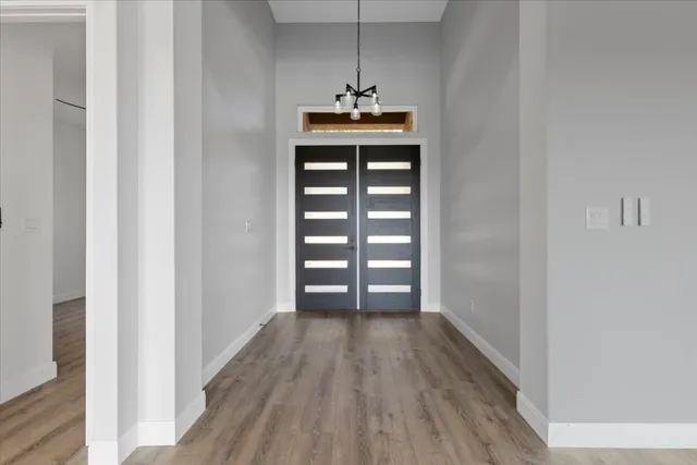 a view of a room with wooden floor and window