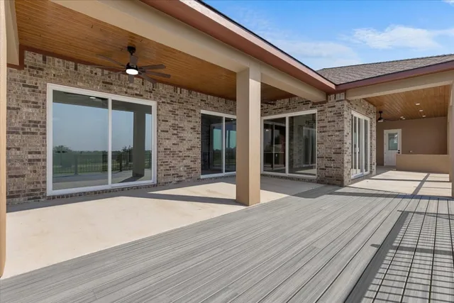 a view of a balcony with wooden floor and seating space