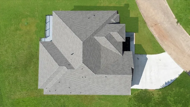 an aerial view of a house with a yard