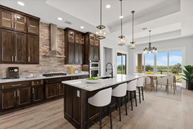 a large kitchen with a table and chairs
