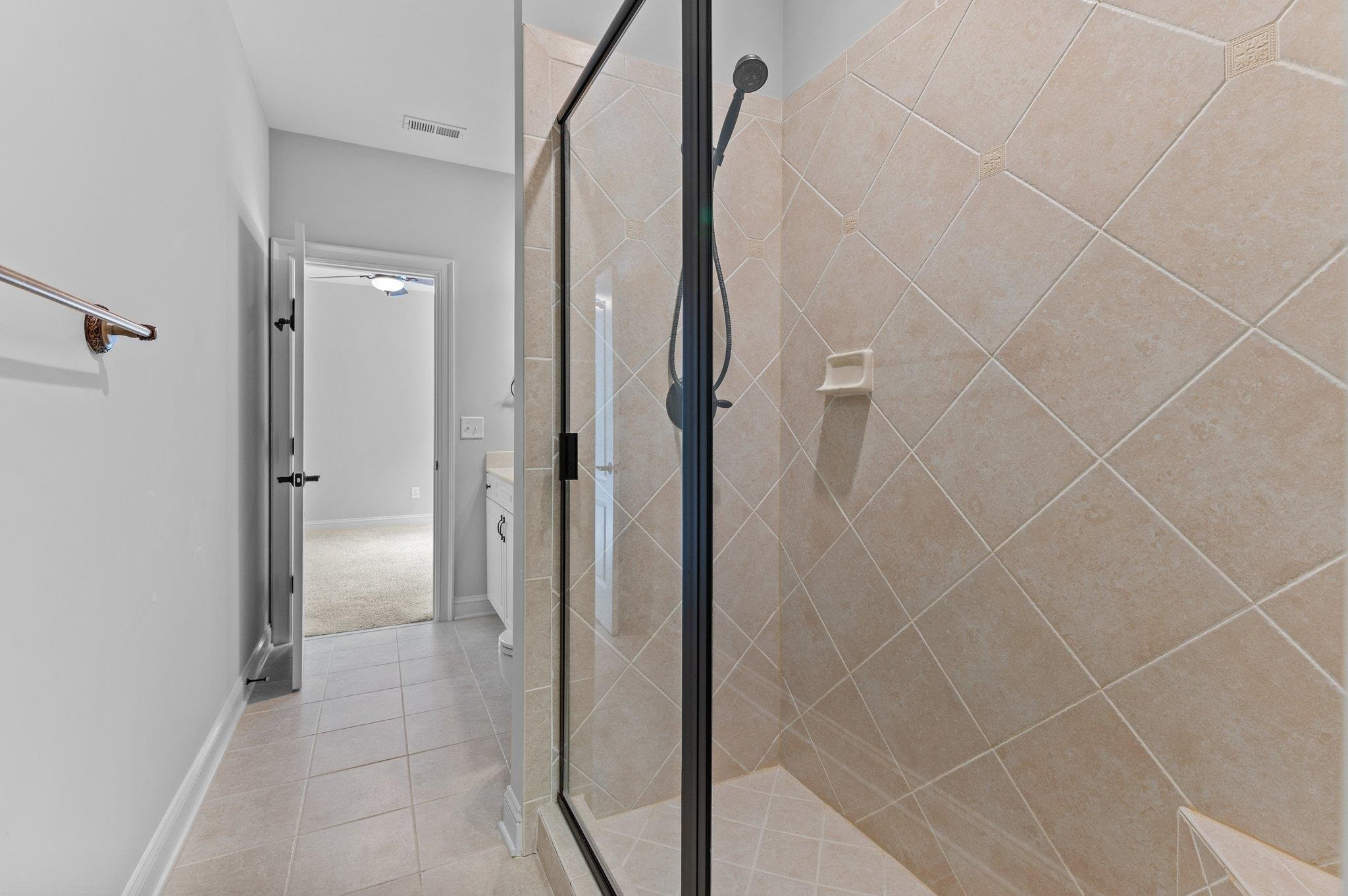 12804 River Dance Drive Raleigh, NC 27613 - Photo 42 of 59 a bathroom with a shower and a glass door