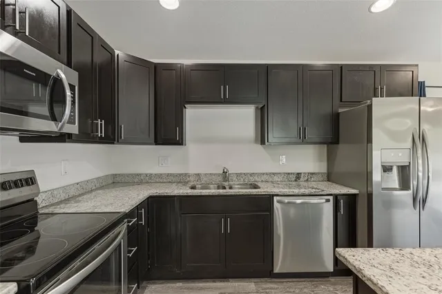a kitchen with a sink appliances and cabinets
