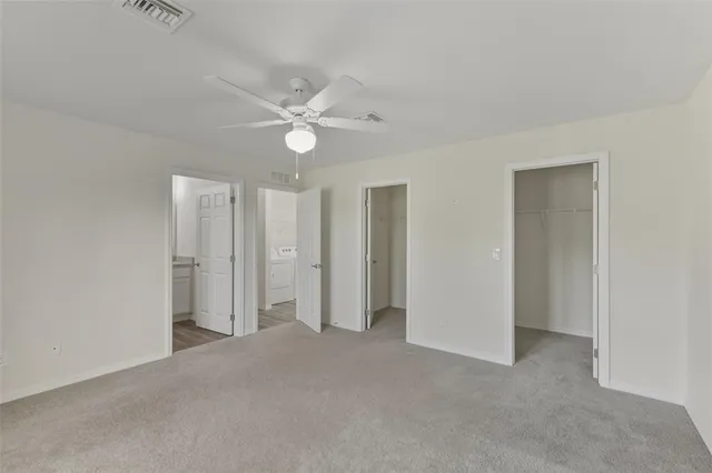 a view of an empty room with a ceiling fan