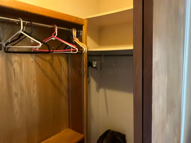 a view of a chair and table in backyard of the house