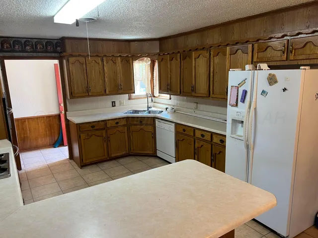 a kitchen with a refrigerator a sink and a stove