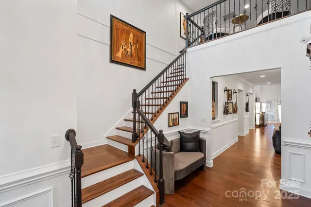 a view of entryway and hall with wooden floor