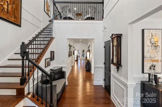 a view of entryway and hall with wooden floor