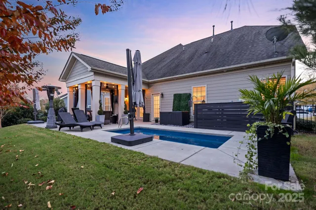 a view of a house with backyard porch and sitting area