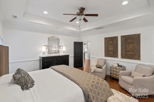 a bedroom with a bed and ceiling fan