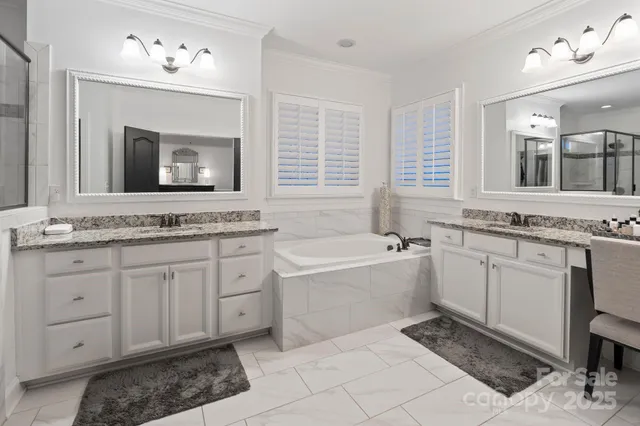 a spacious bathroom with a granite countertop sink mirror and bathtub