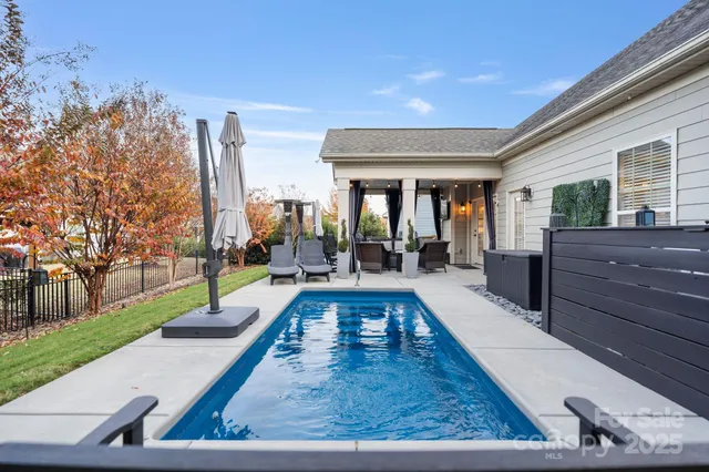a view of a house with backyard porch and sitting area