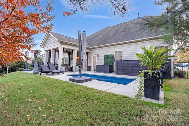 a view of a house with backyard porch and sitting area