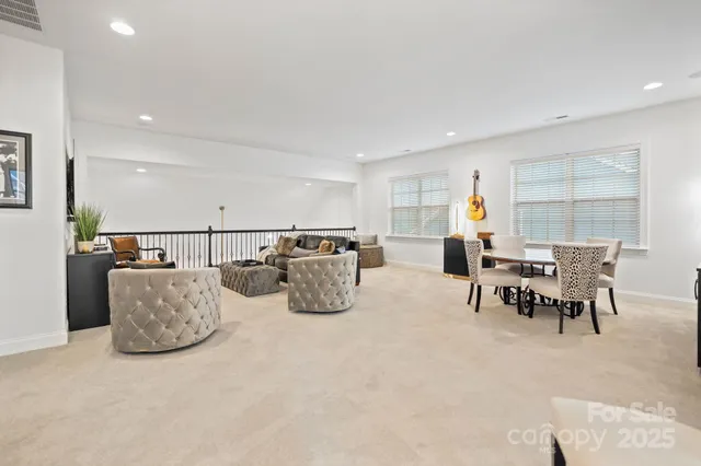 a living room with furniture and a dining table