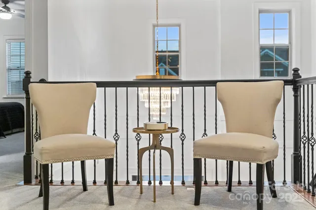 a view of a hallway with furniture and a window