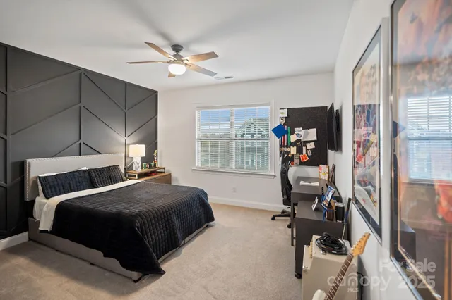 a bedroom with a bed and a chandelier