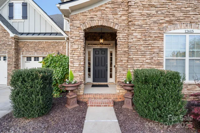 a front view of a house with a garden