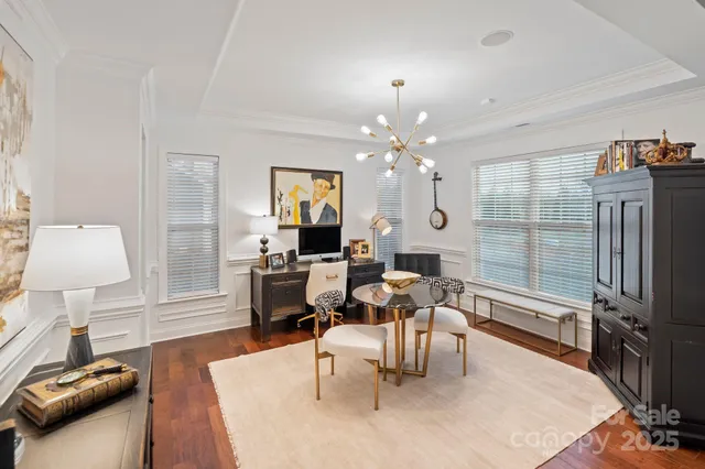 a living room with furniture a chandelier and a flat screen tv